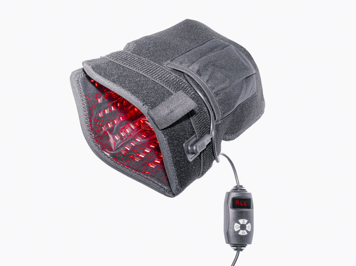 Gray heating pad with red interior and digital controller on a white background
